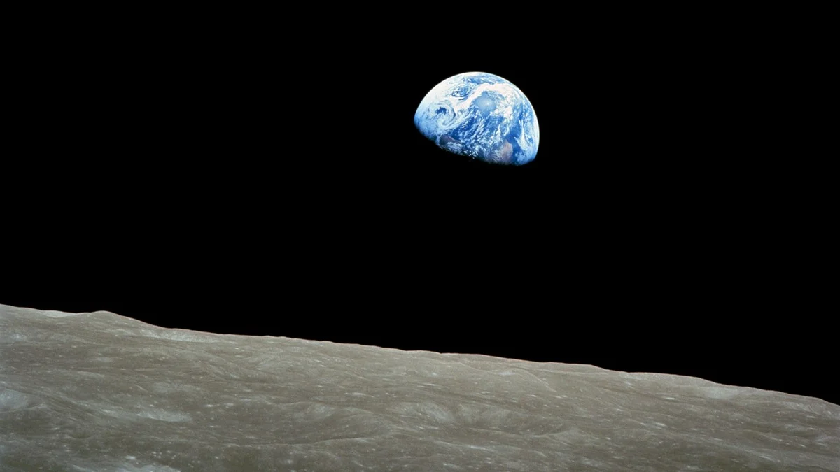 The original Earthrise photograph taken by astronaut William Anders on Apollo 8, 24 December 1968 — Earth rising above the grey lunar horizon against the blackness of space