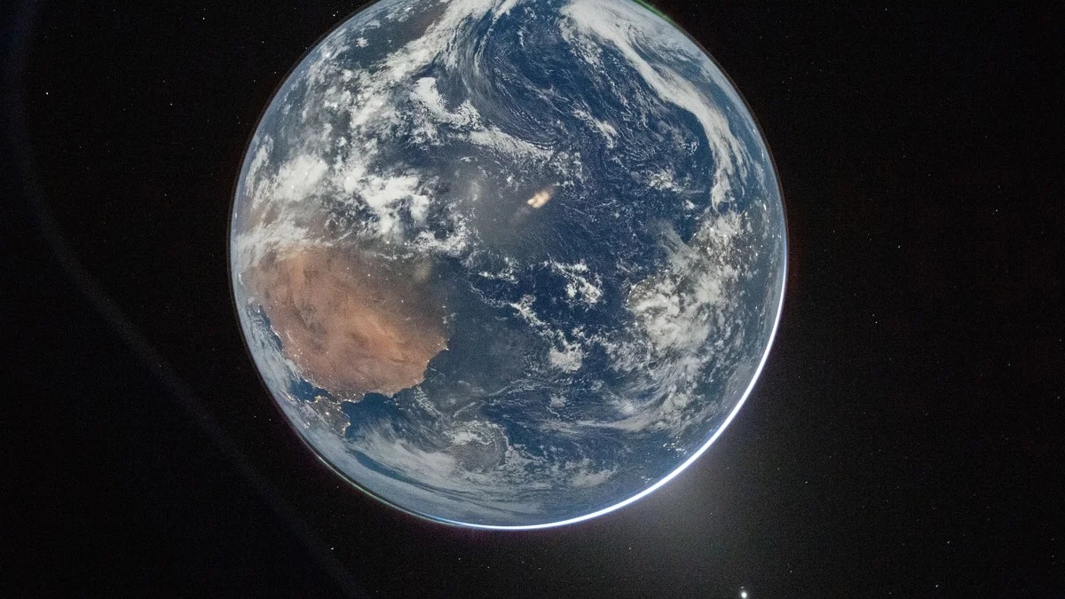 A stunning view of Earth from deep space showing auroras at both poles