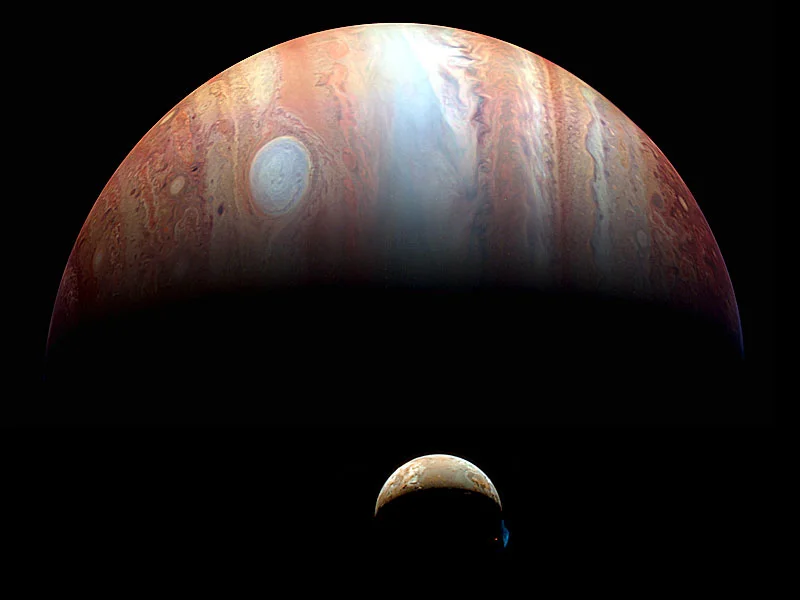Jupiter and volcanic moon Io composite image from New Horizons spacecraft showing Tvashtar volcanic plume erupting above Io's surface