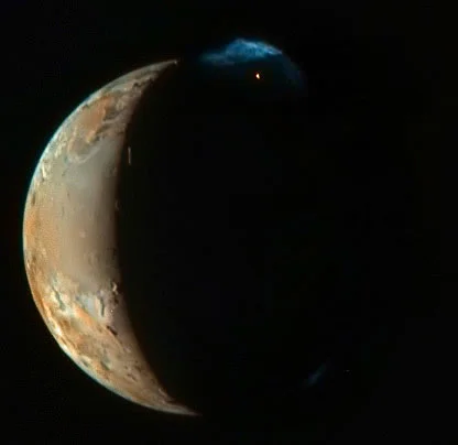 Io moon of Jupiter close-up from New Horizons showing multicoloured volcanic surface with sulphur deposits
